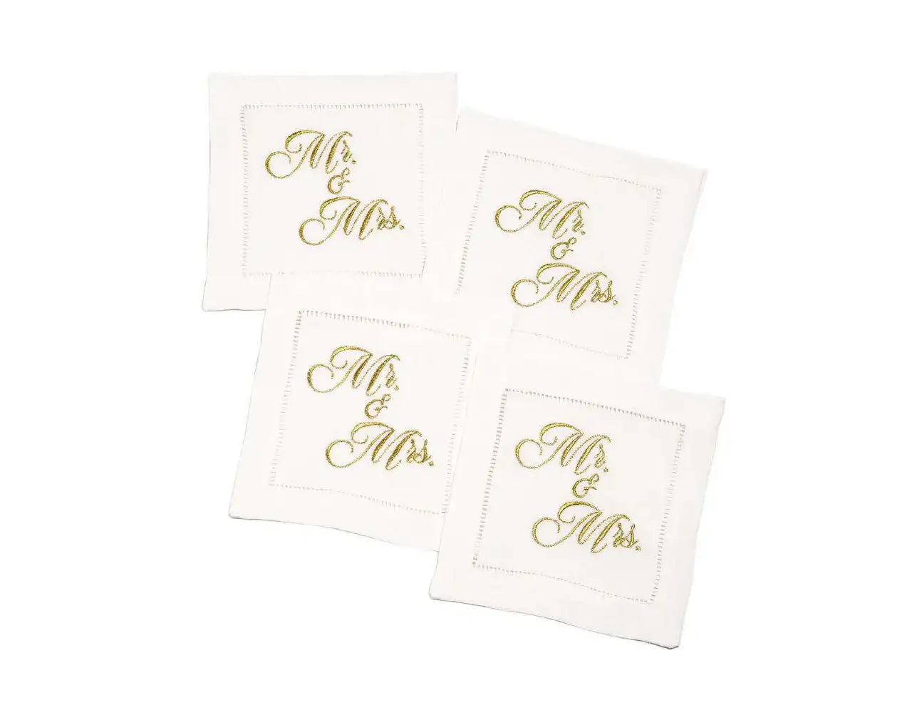 Set of four organic cotton cocktail napkins embroidered with “Mr. & Mrs.” in gold script, by Five Star Napkins.