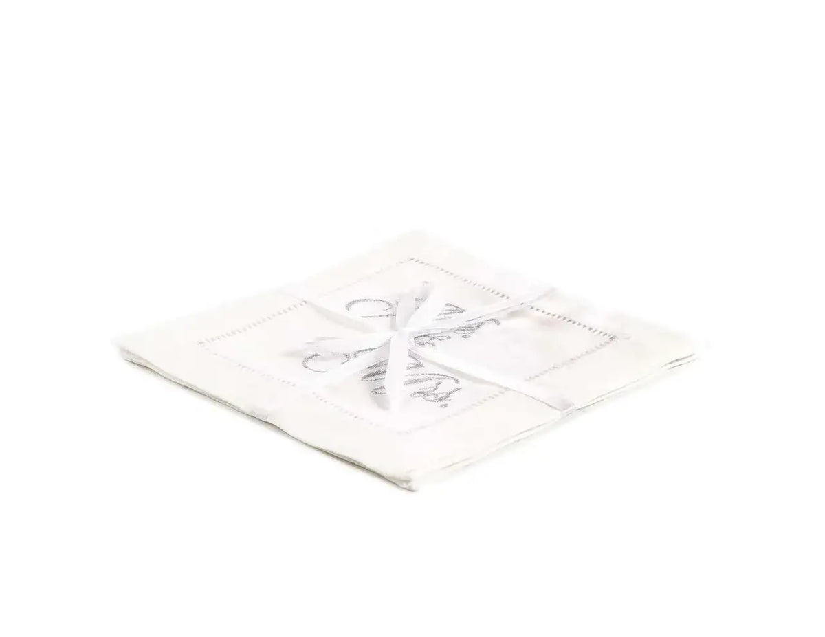 Stack of organic cotton cocktail napkins embroidered with “Mr. & Mrs.” in silver script, tied with a white ribbon, by Five Star Napkins.