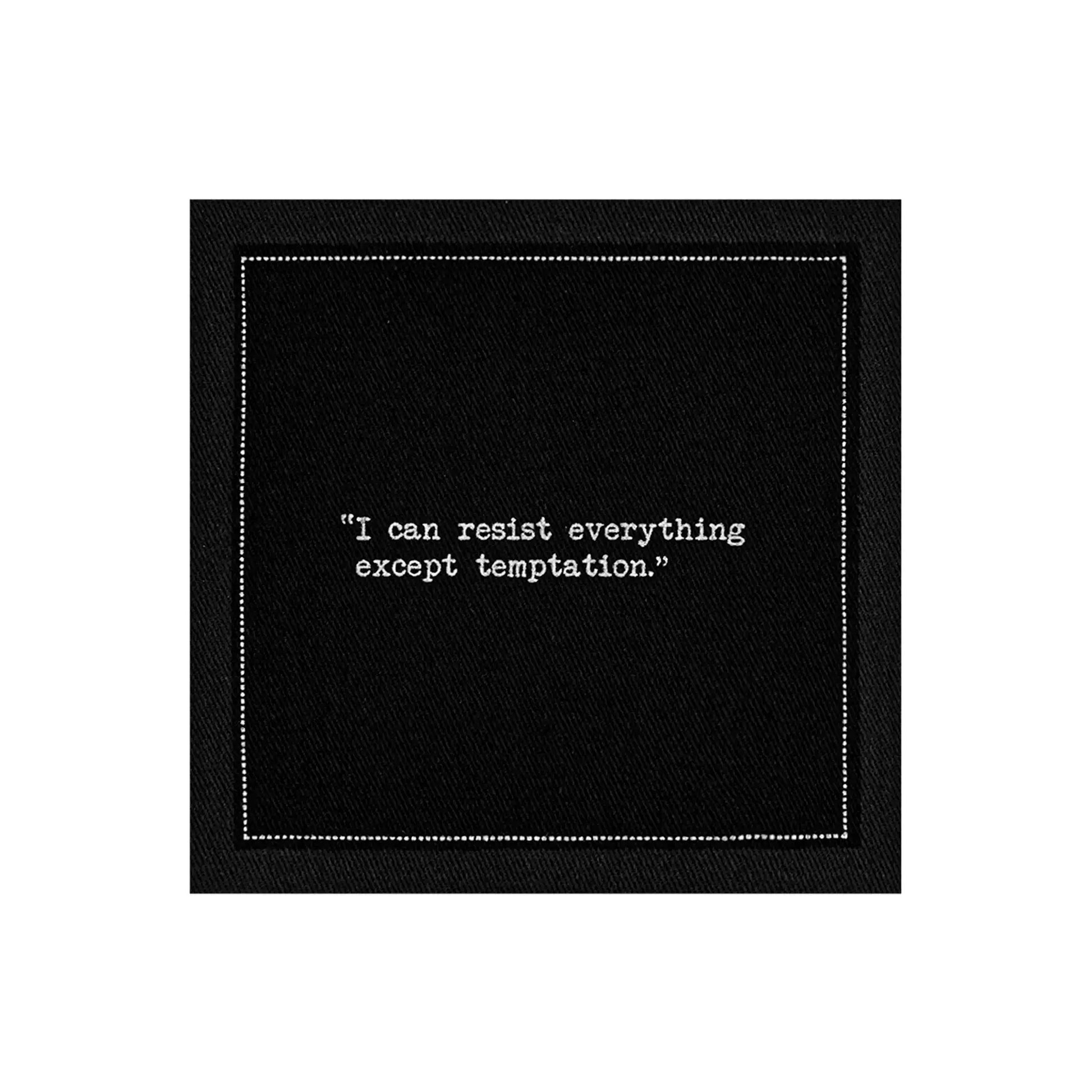 Organic cotton cocktail napkin, black, with white dotted border printed with the quote "I can resist everything except temptation," from Five Star Napkins' Oscar Wilde quote collection
