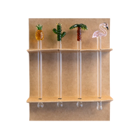 Four glass swizzle sticks — pineapple, cactus, palm tree, and flamingo — displayed in their kraft gift box, by Five Star Napkins.
