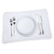 Stack of white organic cotton placemats set with a white plate, fork, and knife, by Five Star Napkins.