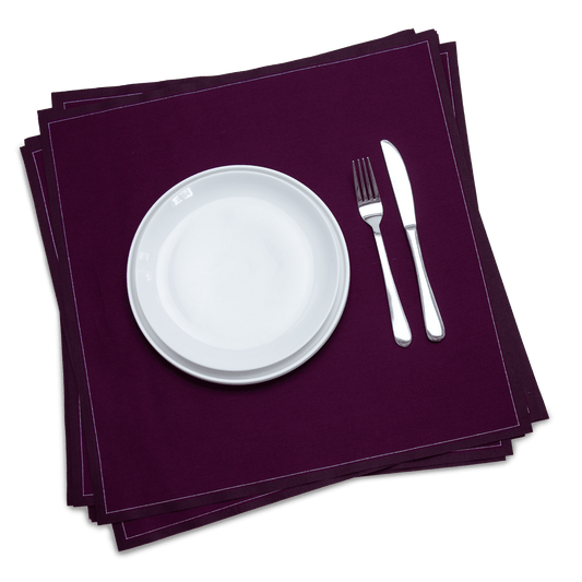 Luxury organic cotton dinner napkins in deep beet color with white plate and silverware