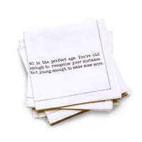 Organic cotton quarter-fold napkin with black dotted border printed with the quote "40 is the perfect age. You're old enough to recognize your mistakes but young enough to make some more," from Five Star Napkins' 40th birthday quote collection