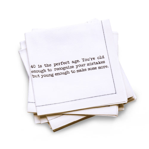 Organic cotton quarter-fold napkin with black dotted border printed with the quote "40 is the perfect age. You're old enough to recognize your mistakes but young enough to make some more," from Five Star Napkins' 40th birthday quote collection