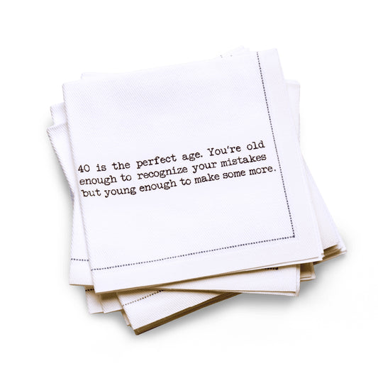 Organic cotton quarter-fold napkin with black dotted border printed with the quote "40 is the perfect age. You're old enough to recognize your mistakes but young enough to make some more," from Five Star Napkins' 40th birthday quote collection