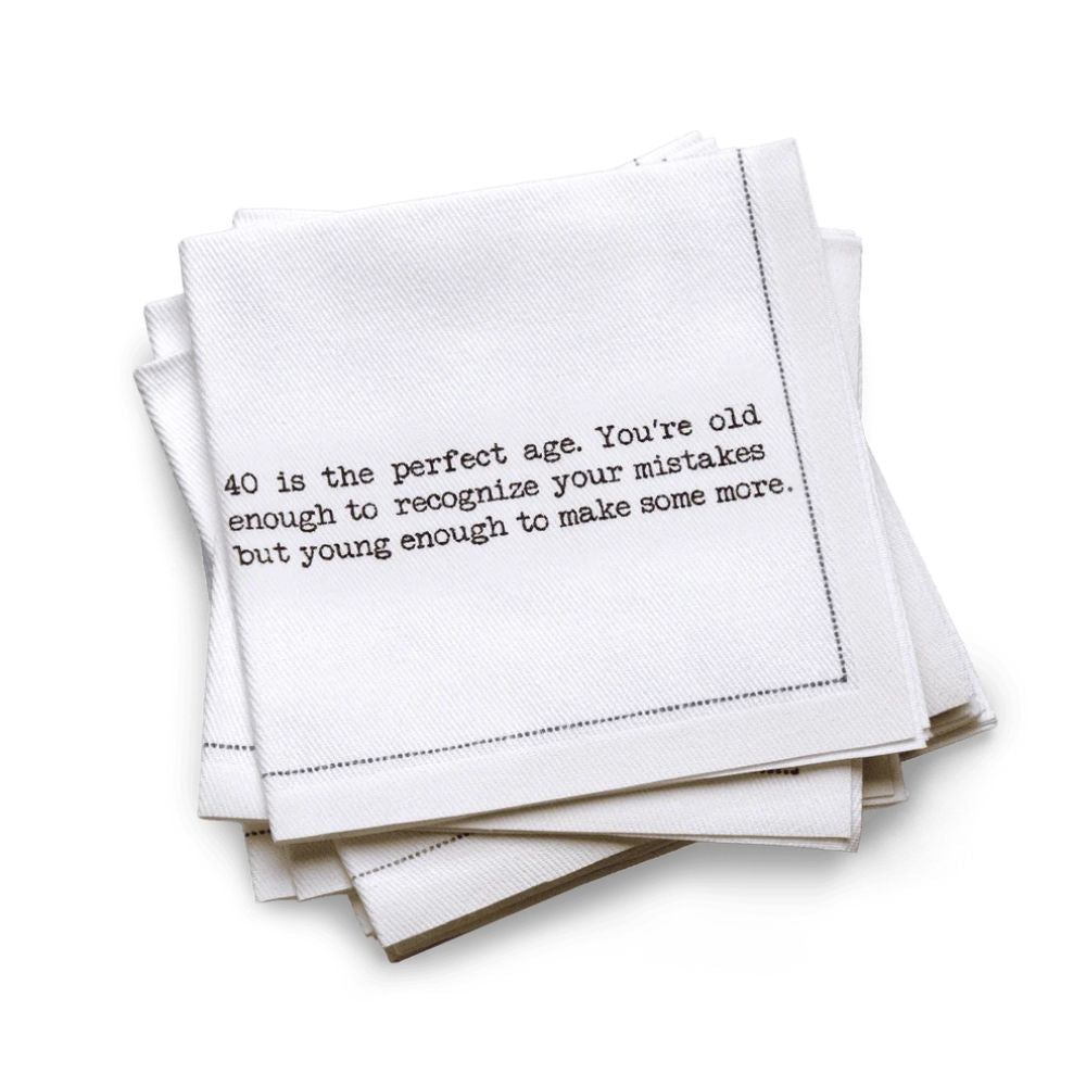 Organic cotton quarter-fold napkin, white, with black dotted border printed with the quote "40 is the perfect age. You're old enough to recognize your mistakes but young enough to make some more," from Five Star Napkins' 40th birthday quote collection