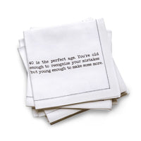 Organic cotton quarter-fold napkin, white, with black dotted border printed with the quote "40 is the perfect age. You're old enough to recognize your mistakes but young enough to make some more," from Five Star Napkins' 40th birthday quote collection