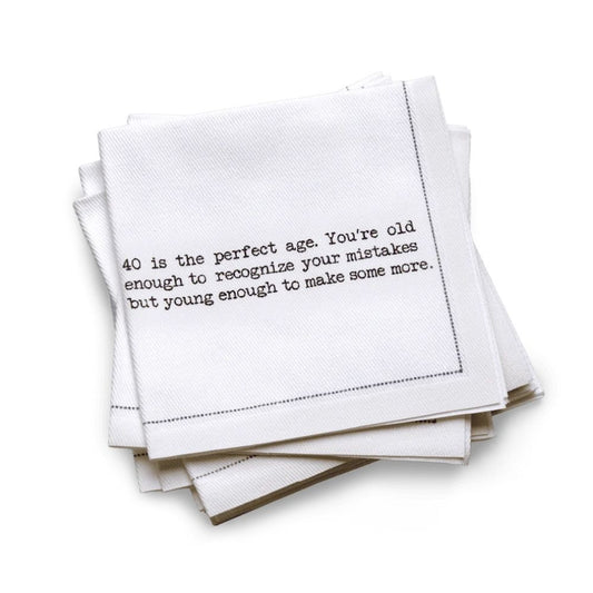 Organic cotton quarter-fold napkin, white, with black dotted border printed with the quote "40 is the perfect age. You're old enough to recognize your mistakes but young enough to make some more," from Five Star Napkins' 40th birthday quote collection
