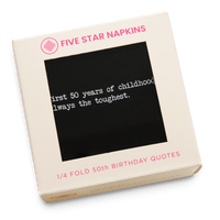 Kraft gift box from Five Star Napkins' 1/4 Fold 50th Birthday Quotes collection, showing an organic cotton quarter-fold napkin, black, printed with the quote "The first 50 years of childhood are always the toughest"