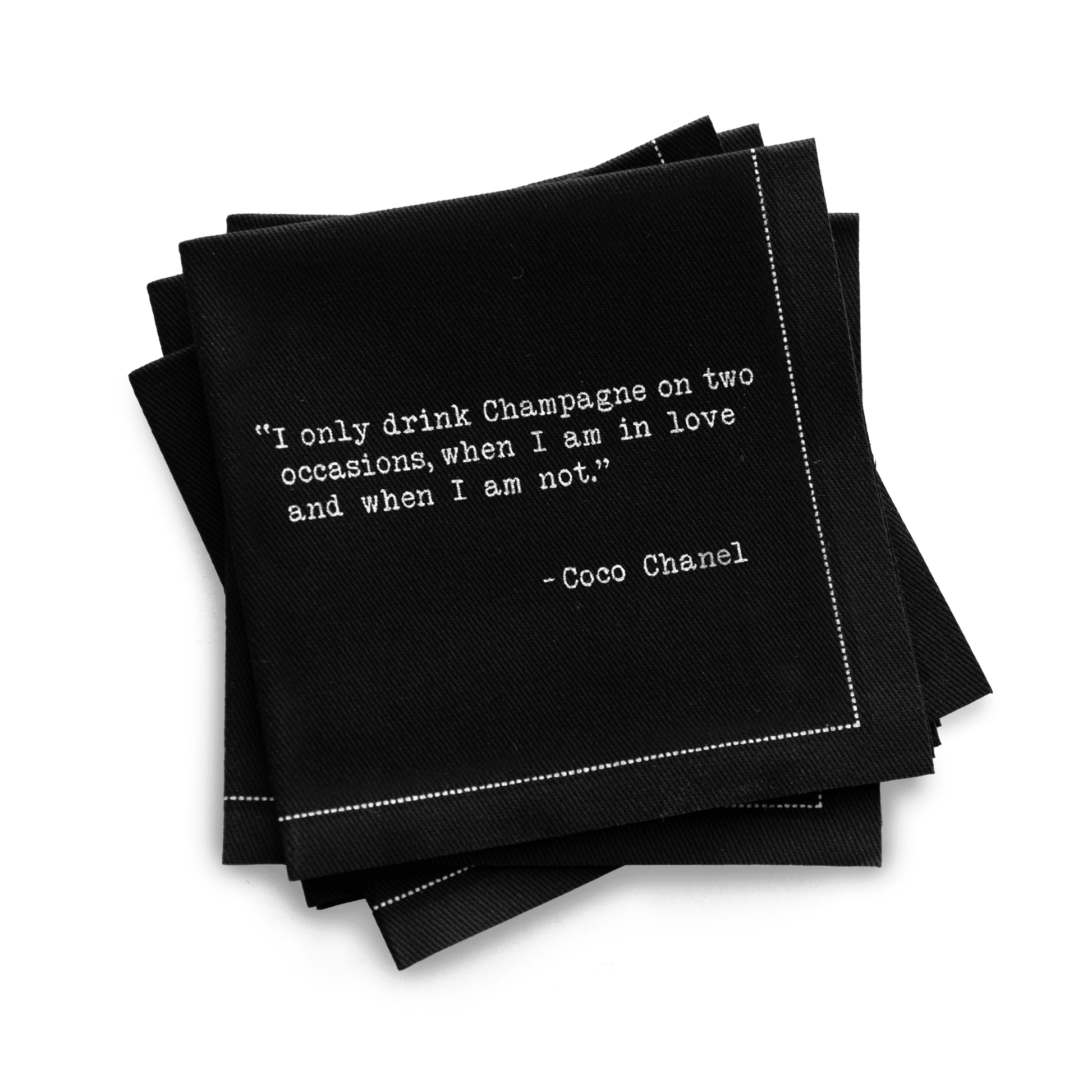 Quarter-fold organic cotton cocktail napkin, black, with white dotted border printed with the Coco Chanel quote "I only drink Champagne on two occasions, when I am in love and when I am not," from Five Star Napkins' Champagne quote collection