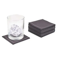 Stack of Anthracite Grey organic cotton cocktail napkins in 1/4 fold, glass with ice on napkin