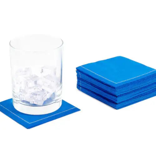 Stack of Royal Blue organic cotton cocktail napkins, one under a glass with ice cubes