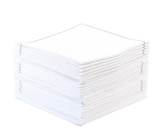Stack of white organic cotton napkins with stitched edges, neatly folded