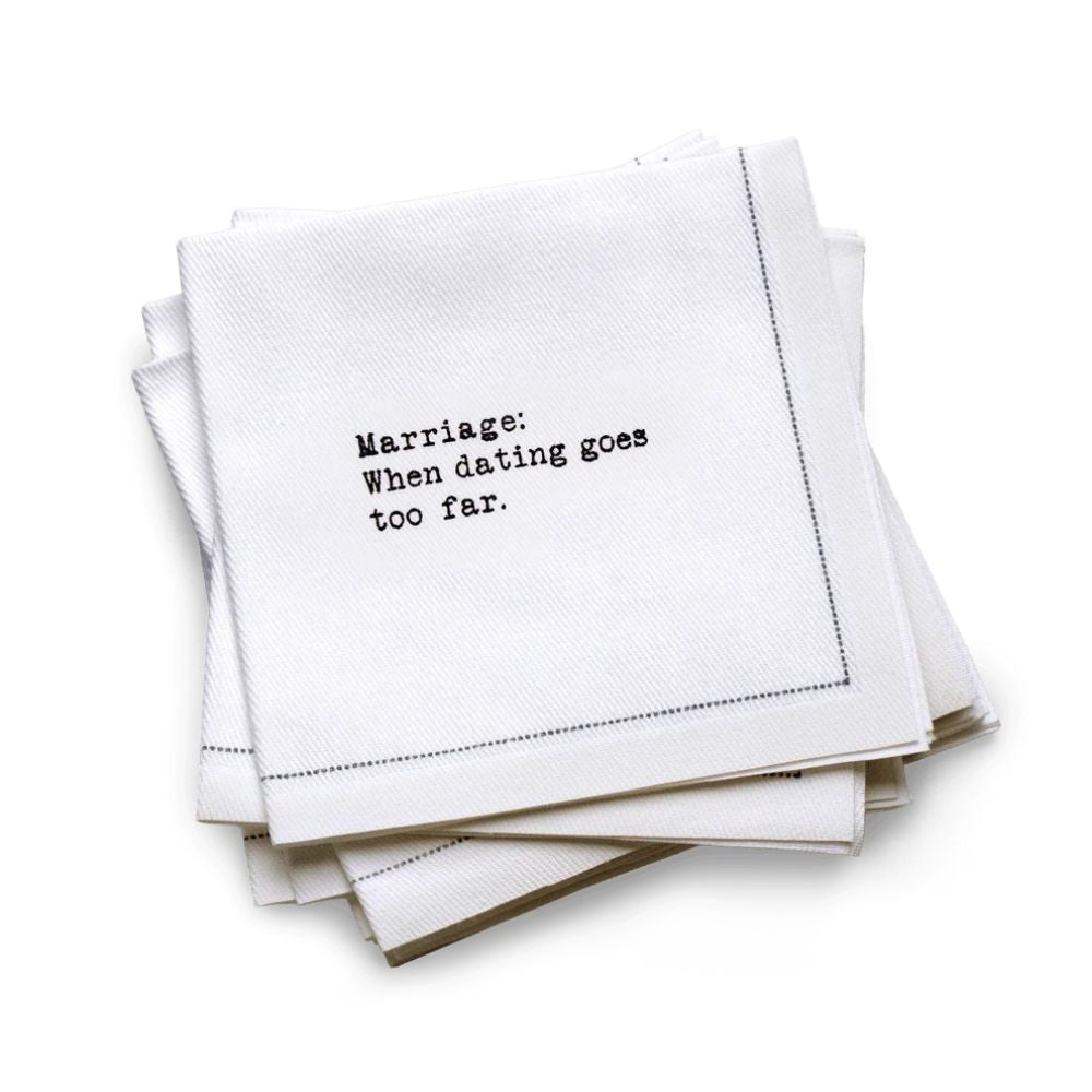 Quarter-fold organic cotton cocktail napkin with black dotted border printed with the quote "Marriage: When dating goes too far," from Five Star Napkins' Drinking Quotes First Edition collection