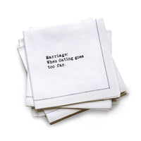 Quarter-fold organic cotton cocktail napkin with black dotted border printed with the quote "Marriage: When dating goes too far," from Five Star Napkins' Drinking Quotes First Edition collection
