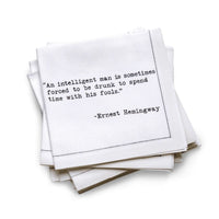 Stack of white napkins with black text quote by Ernest Hemingway on a white background