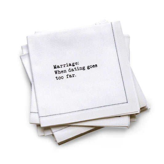 Quarter-fold organic cotton cocktail napkin with black dotted border printed with the quote “Marriage: When dating goes too far,” from Five Star Napkins' Marriage quote collection