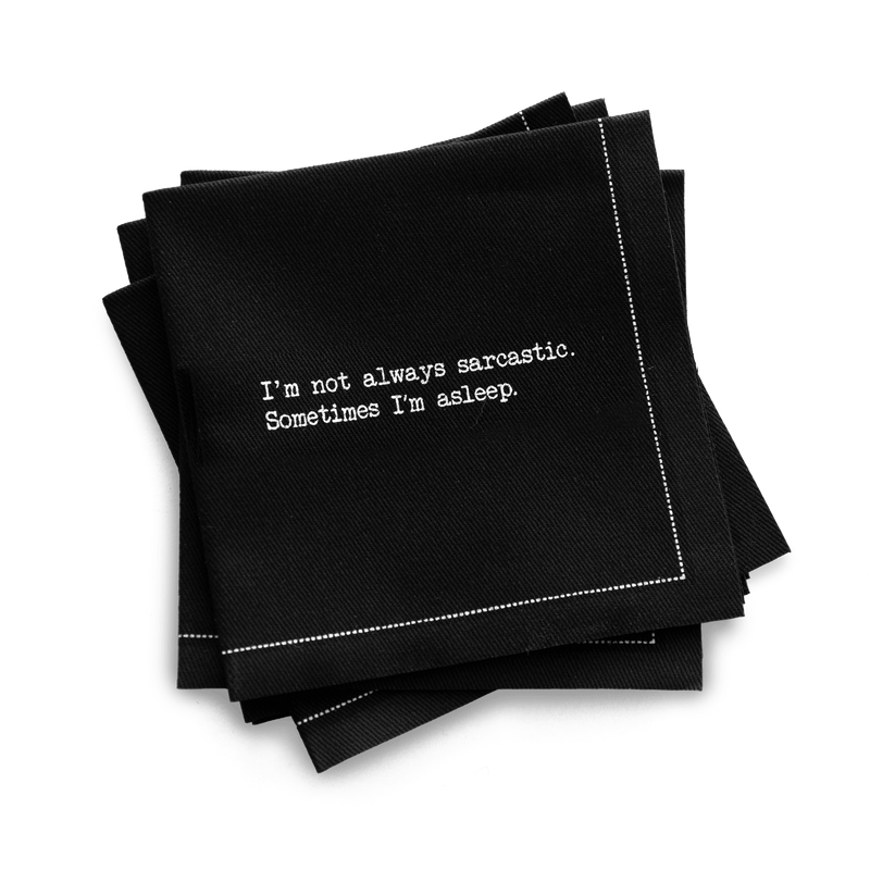 Quarter-fold organic cotton cocktail napkin, black, with white dotted border printed with the quote "I'm not always sarcastic. Sometimes I'm asleep," from Five Star Napkins' Snarky quote collection