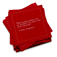 A stack of red Love Quotes cocktail napkins with white dotted borders. The top napkin reads, “They slipped briskly into an intimacy from which they never recovered.” —F. Scott Fitzgerald.