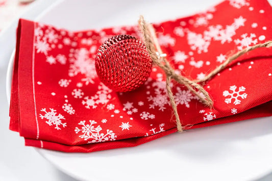 Organic cotton napkin in red with white snowflake pattern, holiday table setting