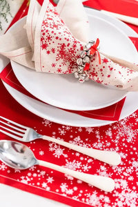 Organic cotton placemat and napkin in Persimmon with white snowflake print in holiday place setting