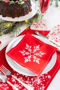 Persimmon organic cotton napkin with white snowflake design on holiday place setting