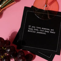 Anthracite Grey organic cotton cocktail napkin with printed quote, wine glass, grapes, and lipstick on a pink surface