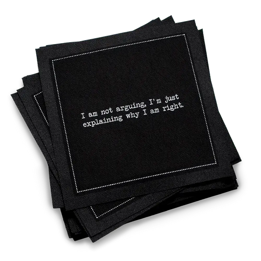 Organic cotton cocktail napkin, black, with white dotted border printed with the quote "I am not arguing, I'm just explaining why I am right," from Five Star Napkins' Snarky quote collection