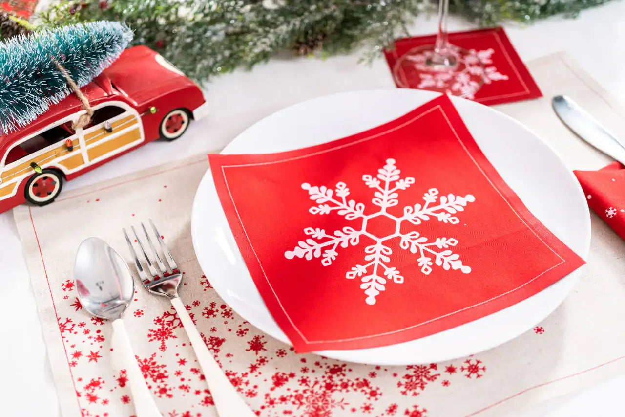 Persimmon organic cotton napkin with white snowflake design on holiday table setting