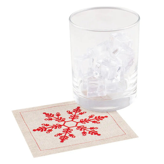 Organic cotton cocktail napkin with red snowflake design under a glass with ice cubes