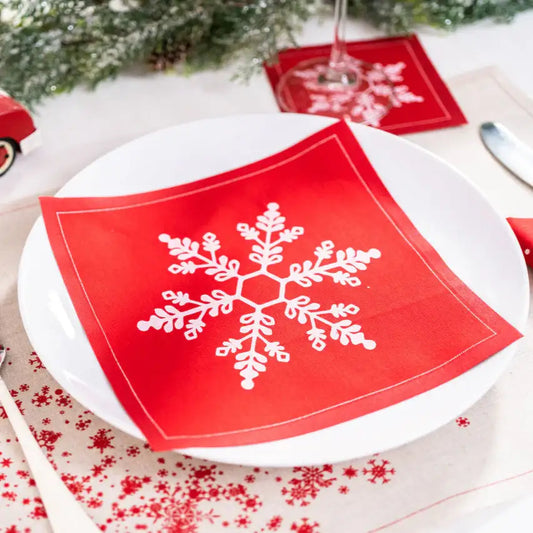 Toreador organic cotton napkin with white snowflake print on a holiday table setting