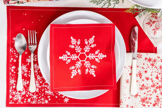 Persimmon organic cotton napkin with white snowflake design on a holiday place setting