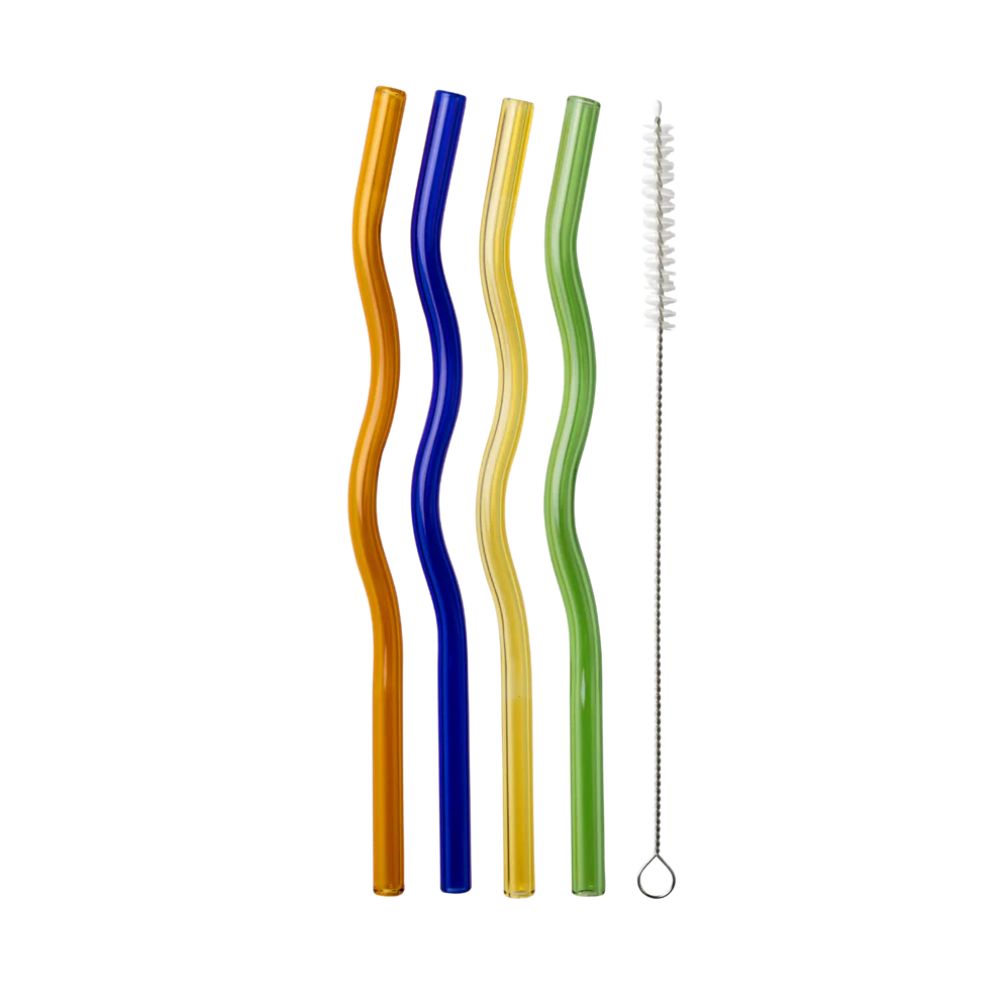 Four wavy glass straws in orange, blue, yellow, and green with a cleaning brush, flat lay on a white background.
