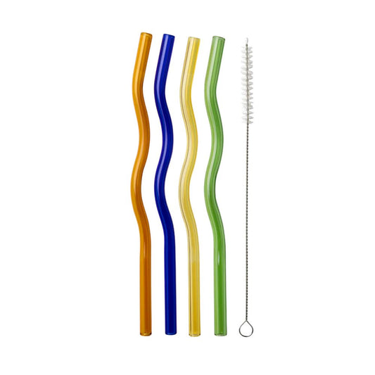 Four wavy glass straws in orange, blue, yellow, and green with a cleaning brush, flat lay on a white background.