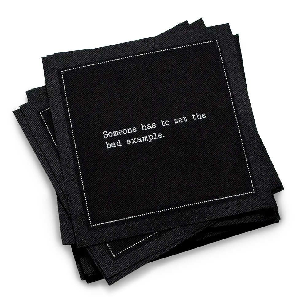 Organic cotton cocktail napkin, black, with white dotted border printed with the quote "Someone has to set the bad example," from Five Star Napkins' Subversive quote collection