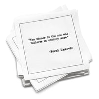 Organic cotton cocktail napkin stack printed with the quote “The winner is the one who believes in victory more,” – Novak Djokovic, from Five Star Napkins’ Tennis Legends quote collection.