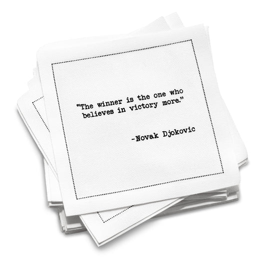 Organic cotton cocktail napkin stack printed with the quote “The winner is the one who believes in victory more,” – Novak Djokovic, from Five Star Napkins’ Tennis Legends quote collection.