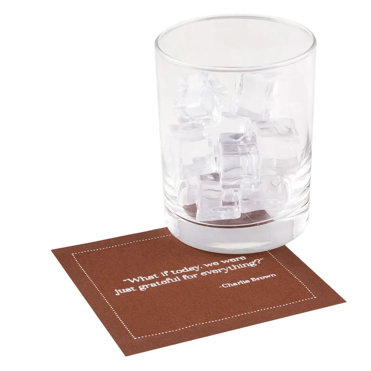 Persimmon organic cotton cocktail napkin with white quote text, glass of ice on top