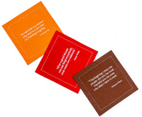 Three organic cotton cocktail napkins in Persimmon, Toreador, and Pickled Beet with Thanksgiving quotes printed.