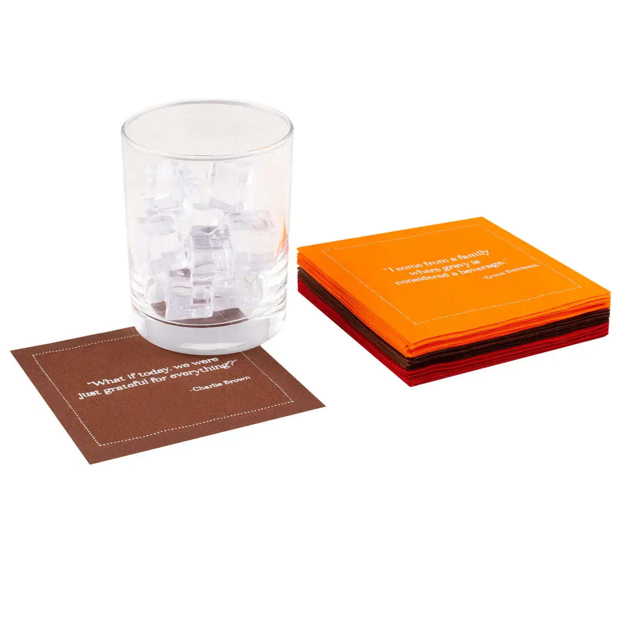 Stack of Persimmon, Anthracite Grey, Pickled Beet organic cotton cocktail napkins with printed quotes, one brown napkin under a glass