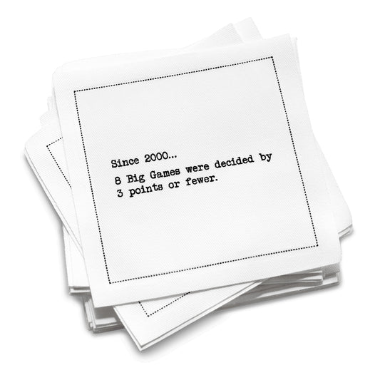 Organic cotton cocktail napkin stack printed with the stat “Since 2000… 8 Big Games were decided by 3 points or fewer,” by Five Star Napkins.