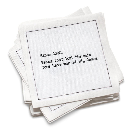 Stack of white cotton cocktail napkins with black text on a white background