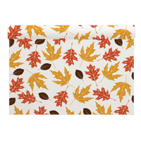 Organic cotton placemat with autumn leaves in Persimmon, Toreador, and Anthracite Grey