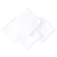 Four white organic cotton square pads with visible soft texture, stacked diagonally