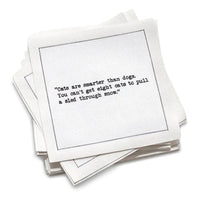 Stack of white cocktail cotton napkins with black text about cat quotes on a white background