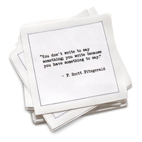 Stack of white cotton cocktail napkins with black text quote by F. Scott Fitzgerald on a white background