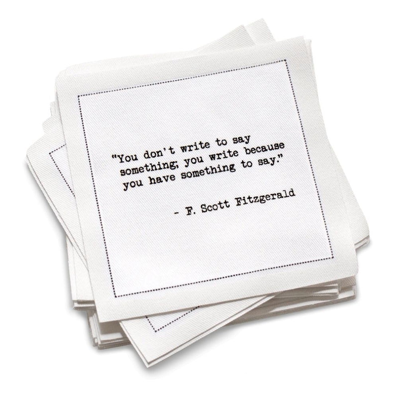 Stack of white cotton cocktail napkins with black text quote by F. Scott Fitzgerald on a white background