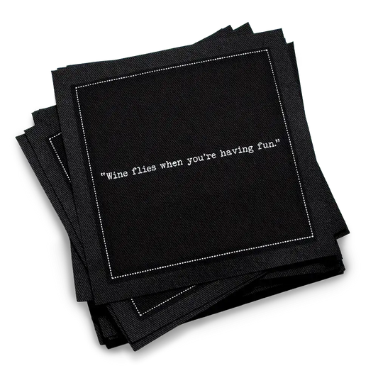 Organic cotton cocktail napkin, black, with white dotted border printed with the quote "Wine flies when you're having fun," from Five Star Napkins' Wine quote collection