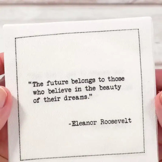 Video close-up of an organic cotton cocktail napkin printed with the quote “The future belongs to those who believe in the beauty of their dreams,” – Eleanor Roosevelt, from Five Star Napkins’ Women Leaders quote collection.